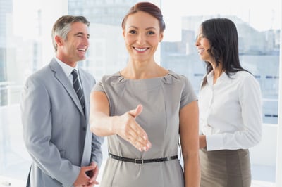 Business people welcoming new staff to work