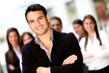 Male business leader looking confident with a group